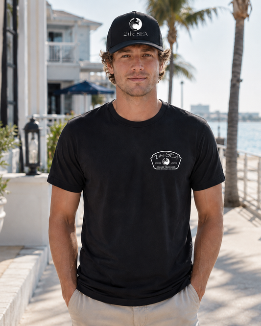 Front lifestyle view of The Mark dark grey 2theSEA T-shirt featuring the small light Change Your Gear badge graphic on the left chest.