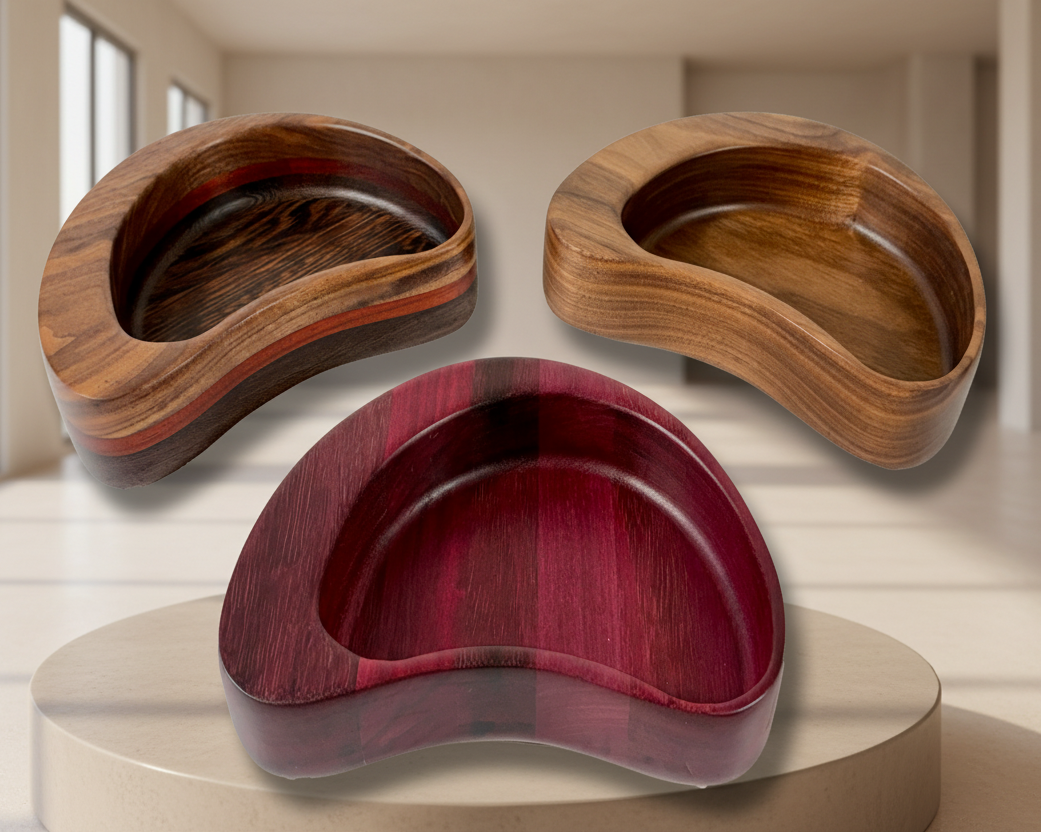 Three wooden kidney-shaped bowls of different colors 