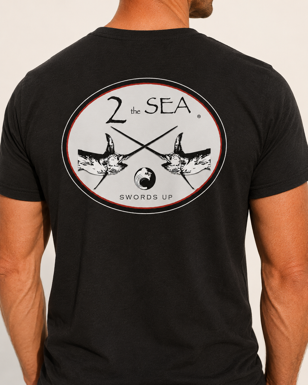 Close-up back view of The Crossing Black 2theSEA T-shirt showing the large crossed-swordfish graphic.