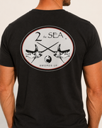 Close-up back view of The Crossing Black 2theSEA T-shirt showing the large crossed-swordfish graphic.