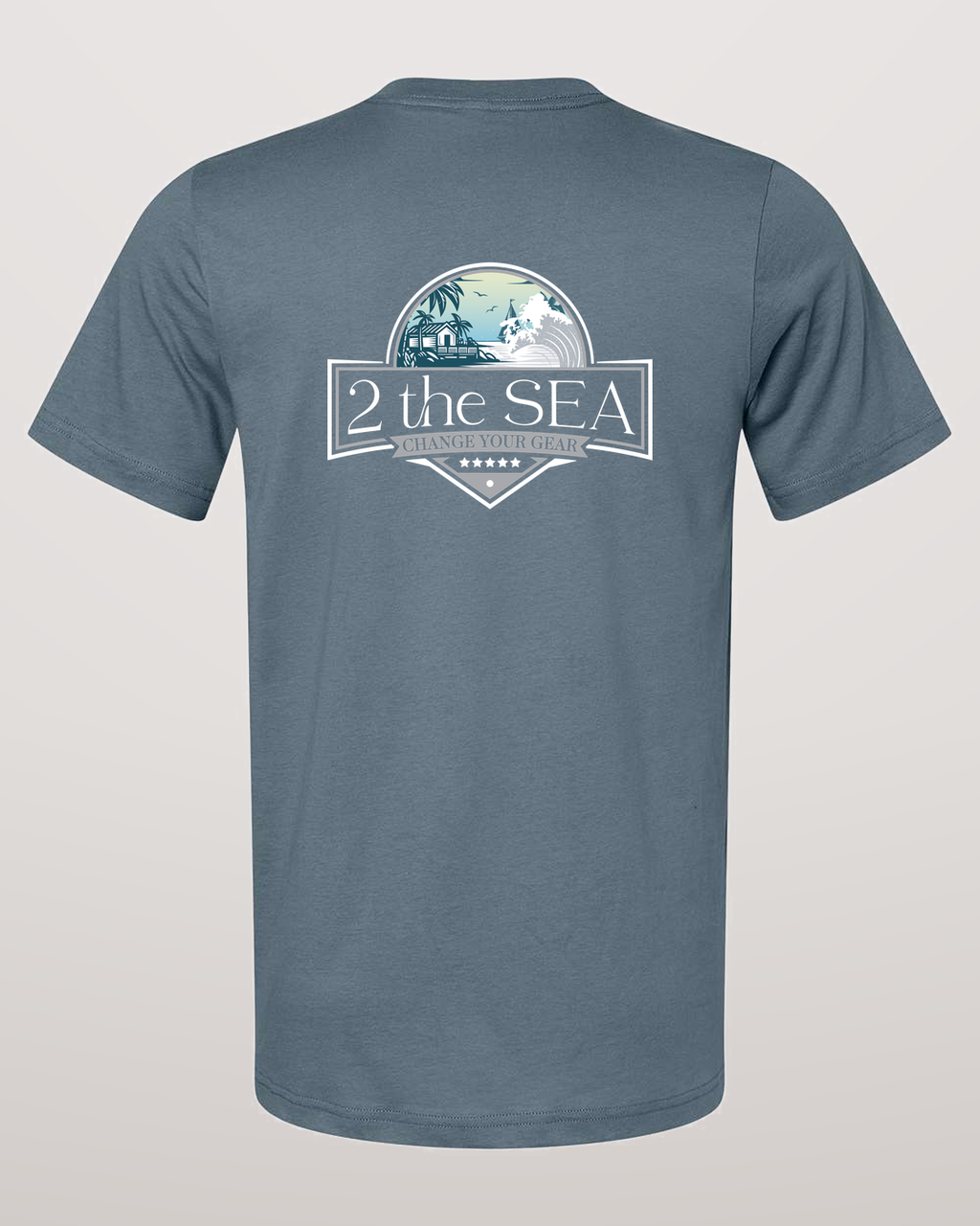 Studio back view of the Shore House Slate Blue 2theSEA T-shirt featuring the large house, palm and wave graphic centered on the back.