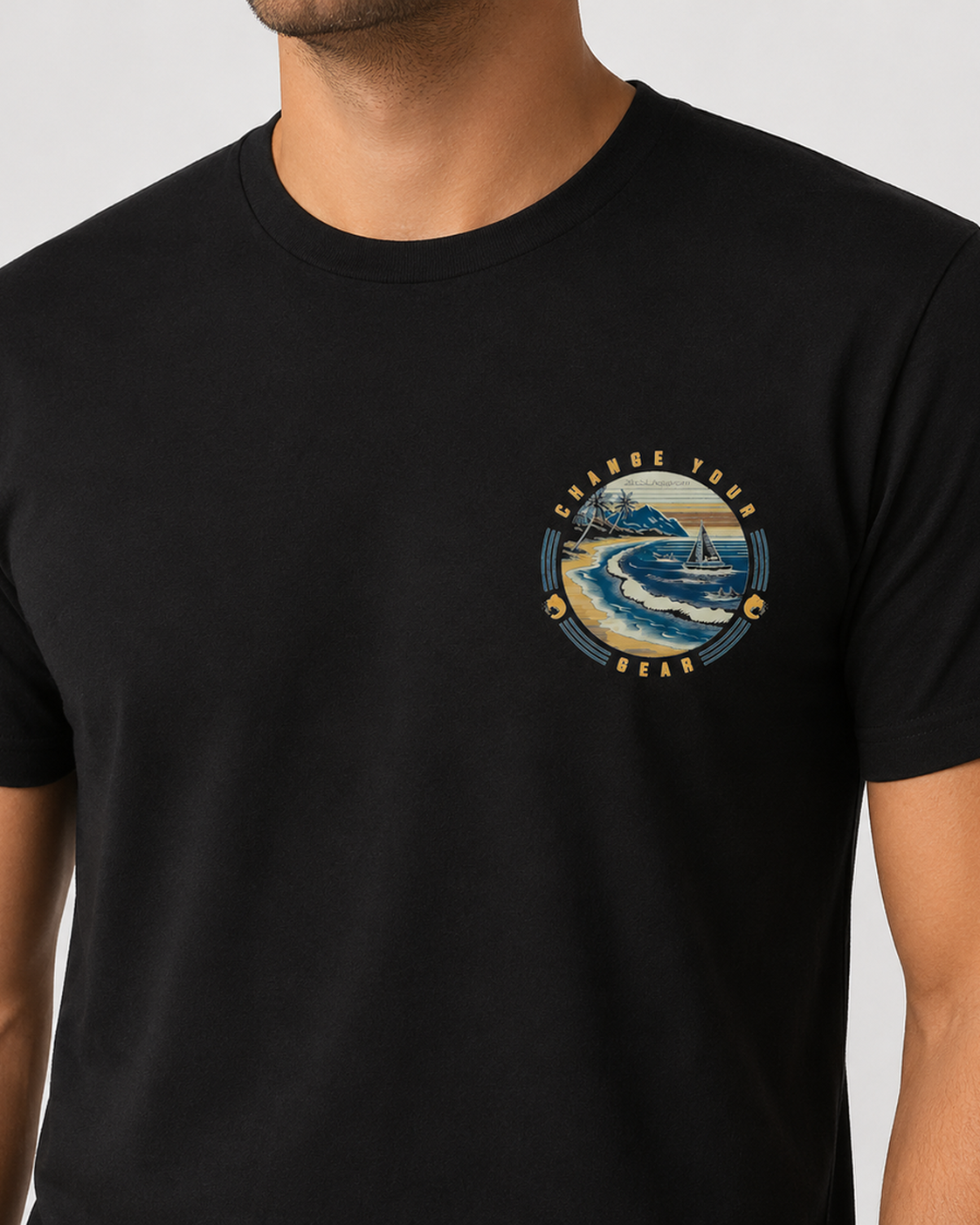 Close-up front view of The Passage Black 2theSEA T-shirt showing the shoreline, sailboat and wave graphic on the left chest.