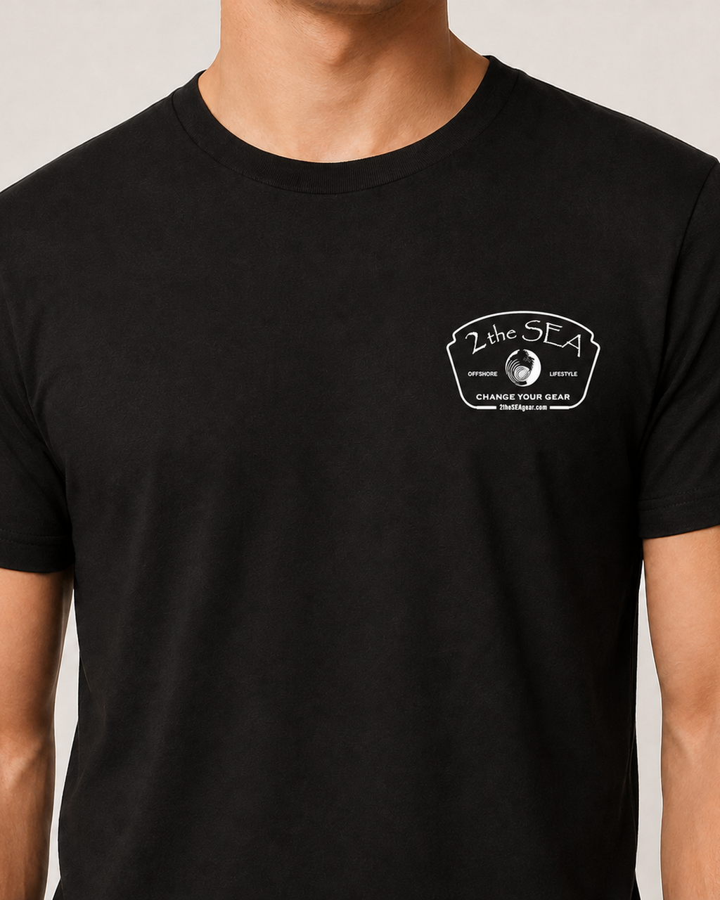 Close-up front view of The Mark dark grey 2theSEA T-shirt showing the light Change Your Gear badge graphic on the left chest.