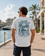 Back lifestyle view of the Change of Course Ash 2theSEA T-shirt featuring the large Change Your Gear van and palm graphic in a marina setting.