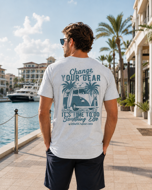 Back lifestyle view of the Change of Course Ash 2theSEA T-shirt featuring the large Change Your Gear van and palm graphic in a marina setting.